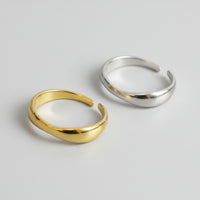 Gold and silver open rings on a gray background